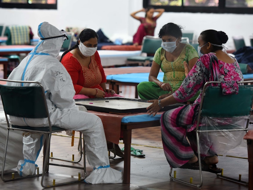 caption: Coronavirus patients play a game of carrom inside the COVID-19 Care Centre at CWG Village Sports Complex in New Delhi on Thursday.