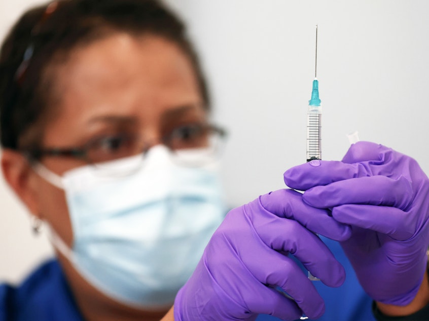 caption: Pharmacist LaChandra McGowan prepares a dose of the Pfizer COVID-19 vaccine at a clinic operated by DePaul Community Health in New Orleans in August. Soon, children ages 5 to 11 could be eligible for Pfizer shots.