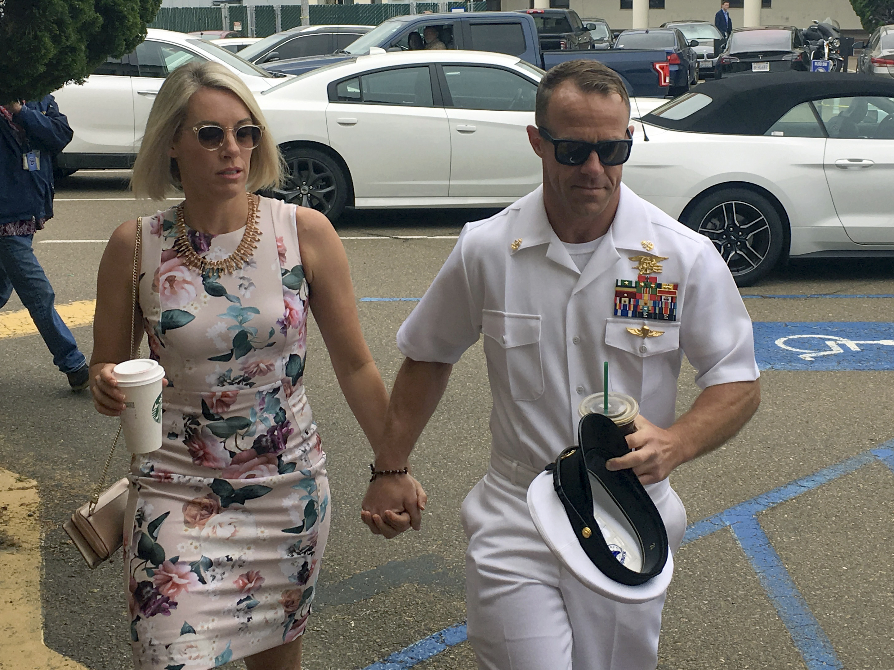 caption: Navy Special Operations Chief Edward Gallagher and his wife, Andrea Gallagher, arrive at military court on Naval Base San Diego on Thursday. A witness stunned prosecutors after testifying that he, not Gallagher, killed an ISIS fighter in 2017.