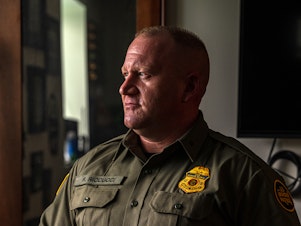 caption: Ryan Riccucci, division chief of law enforcement operational programs for U.S. Customs and Border Protection, says he feels his agency is often misunderstood by the U.S. public. Here, he poses for a portrait in his office at the Tucson Sector headquarters in Arizona on March 26.