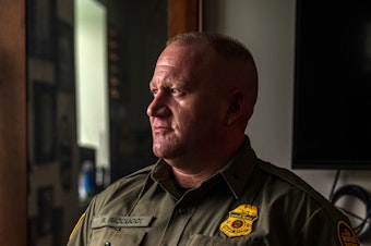 caption: Ryan Riccucci, division chief of law enforcement operational programs for U.S. Customs and Border Protection, says he feels his agency is often misunderstood by the U.S. public. Here, he poses for a portrait in his office at the Tucson Sector headquarters in Arizona on March 26.
