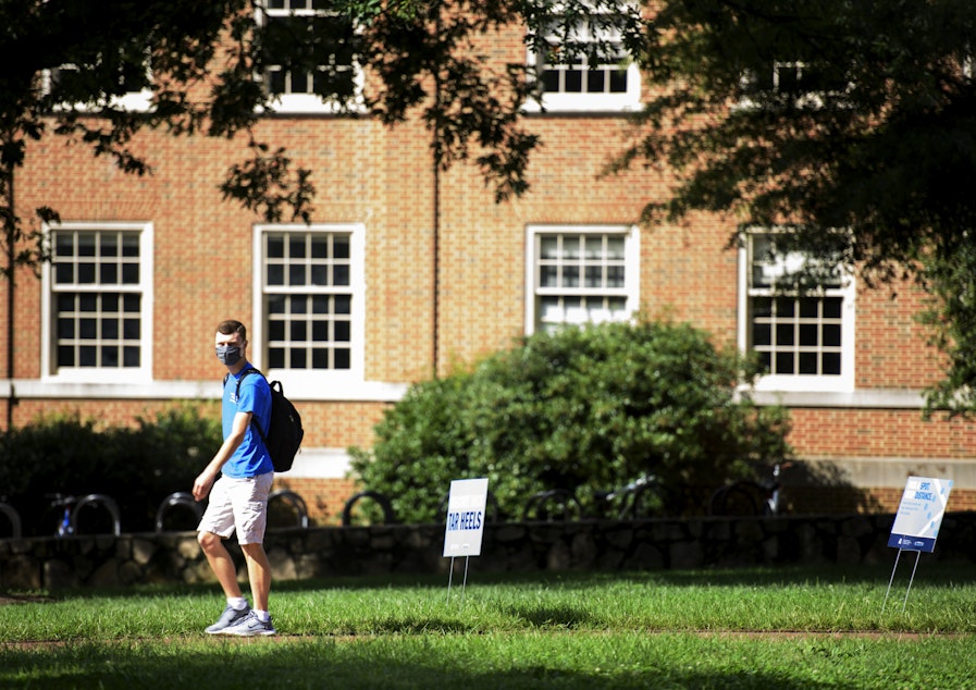 caption: A student walks through the campus of the University of North Carolina at Chapel Hill on August 18, 2020 in Chapel Hill, North Carolina. (Melissa Sue Gerrits/Getty Images)