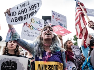 caption: Abortion-rights supporters await the decision at the Supreme Court.