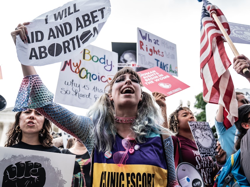 caption: Abortion-rights supporters await the decision at the Supreme Court.