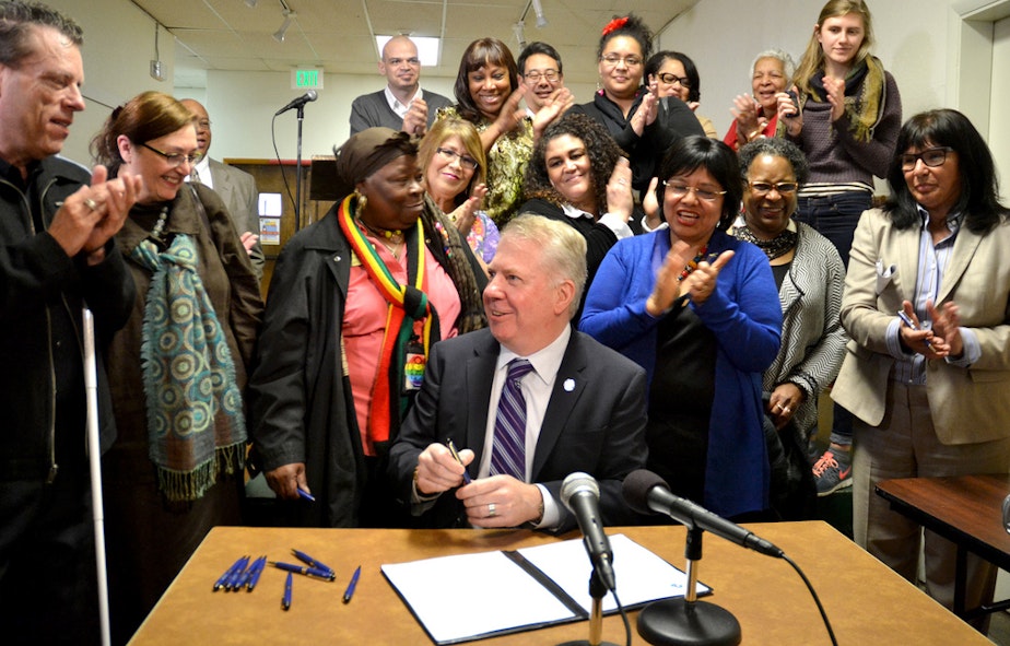 caption: Ed Murray signed an racial equity executive order on Thursday, April 3, to a chorus of applause.