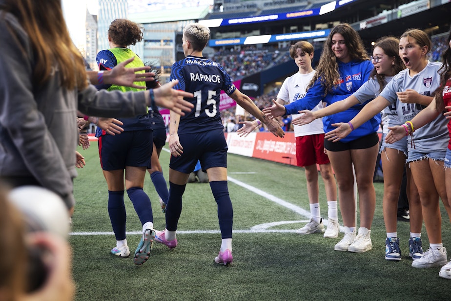 caption: Young fans react after high-fiving OL Reign forward Megan Rapinoe as she walks onto the field to play her final NWSL regular-season home game against the Washington Spirit on Friday, Oct. 6, 2023, at Lumen Field in Seattle. 