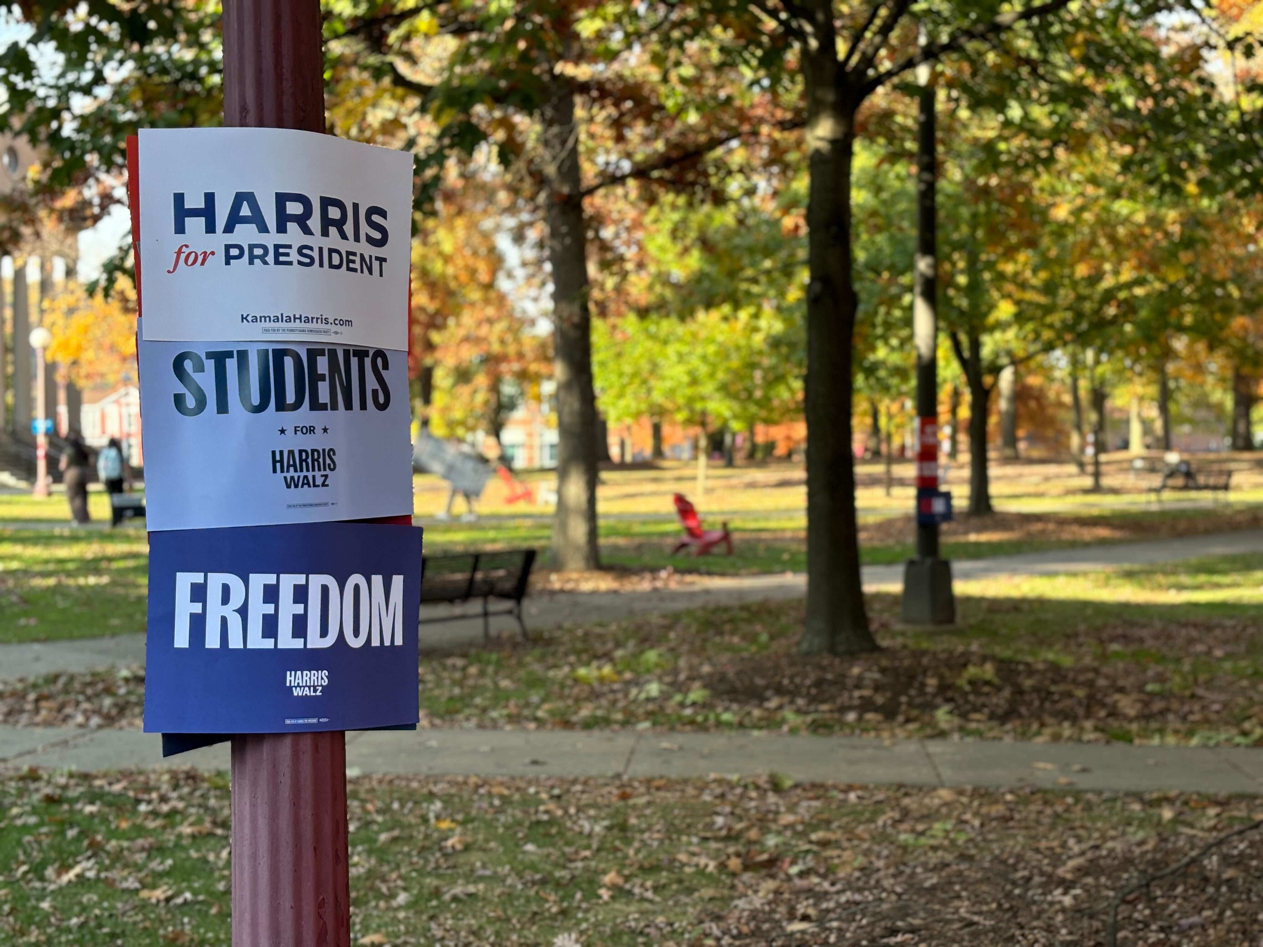 caption: Students for Harris Walz signs hang at Indiana University of Pennsylvania ahead of a Get Out The Vote rally on Oct. 23, organized by the school's young Democrats.