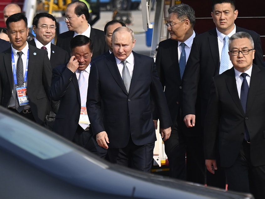 caption: Russia's President Vladimir Putin, center, arrives at Beijing Capital International Airport to attend the third Belt and Road Forum in Beijing, Tuesday, Oct. 17, 2023.