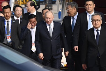 caption: Russia's President Vladimir Putin, center, arrives at Beijing Capital International Airport to attend the third Belt and Road Forum in Beijing, Tuesday, Oct. 17, 2023.