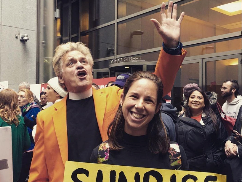 caption: Reverend Billy (William Talen, left) among a flock of supporters.
