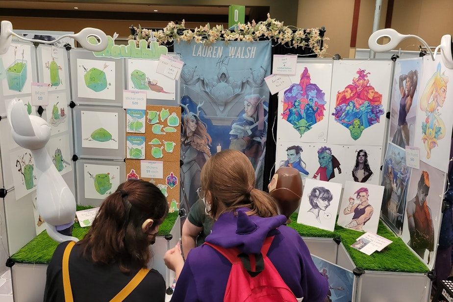 caption: Philadelphia artist Lauren Walsh sells artwork at Emerald City Comic Con, including her happy Gelatinous Cube, Woubble.