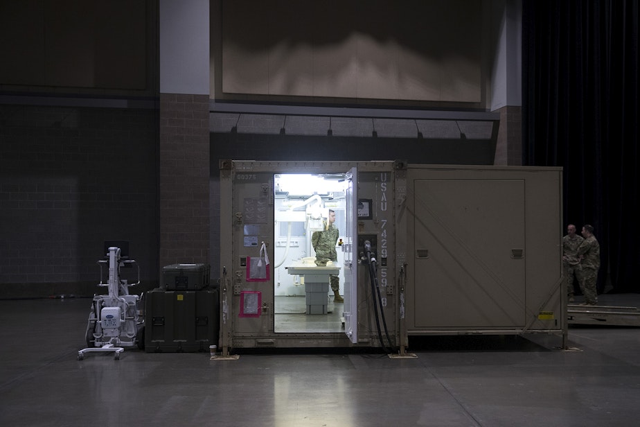 caption: U.S. Army soldiers stand in the x-ray area of the military field hospital being deployed by soldiers from the 627th Army Hospital from Fort Carson, Colorado, as well as from Joint Base Lewis-McChord on Tuesday, March 31, 2020, at the CenturyLink Field Event Center in Seattle.