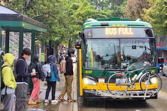 caption: UW students line up to board a Metro bus on Monday, Oct. 2, 2023.