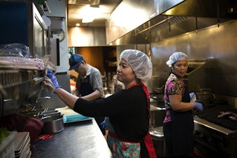 caption: Tamarind Tree employees from left, Tin Dang, Loan Luong, and Mui Tang work in the kitchen on Thursday, October 12, 2017, at the restaurant in Seattle's Little Saigon neighborhood. Click or tap on the first image to see more.
