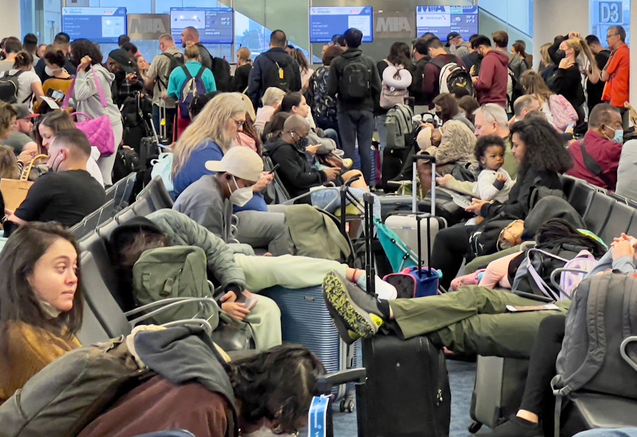 caption: Dr. Anthony Fauci, chief medical adviser to President Biden, cites the U.S. vaccination program and previous widespread transmission of COVID-19 as reasons why the country is not now under pandemic conditions. Here, travelers are seen at Miami International Airport last week, after mask requirements were lifted.