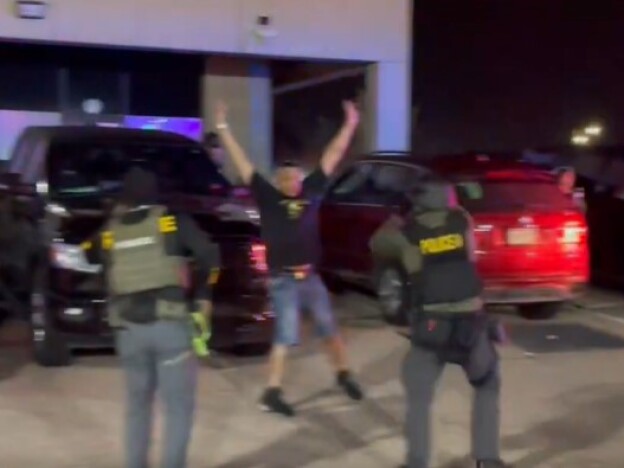 caption: This screenshot from a video posted on X by the Drug Enforcement Administration's Rocky Mountain Division shows law enforcement officers raiding a nightclub in Colorado Springs.
