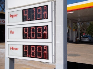 caption: A sign displays fuel prices at a gas station in Arlington, Va., on March 16. President Biden announced on Thursday the country's largest-ever release from its Strategic Petroleum Reserve.