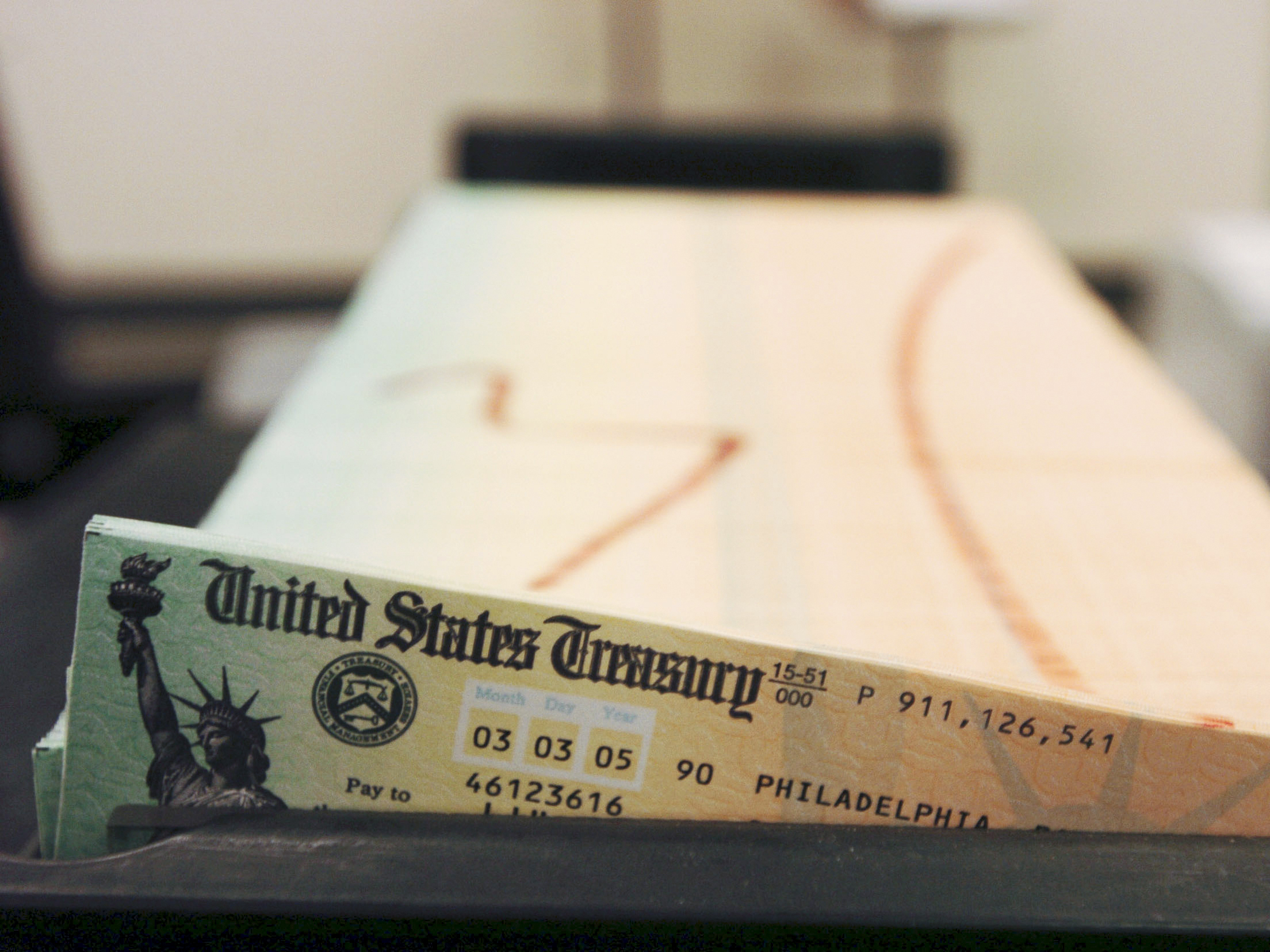 caption: In this Feb. 11, 2005 file photo, trays of printed social security checks wait to be mailed from the U.S. Treasury's Financial Management services facility in Philadelphia. The financial impact of the coronavirus pandemic on Social Security and Medicare is front and center as the government releases its annual report on the state of the bedrock retirement programs on Tuesday, Aug. 31, 2021.
