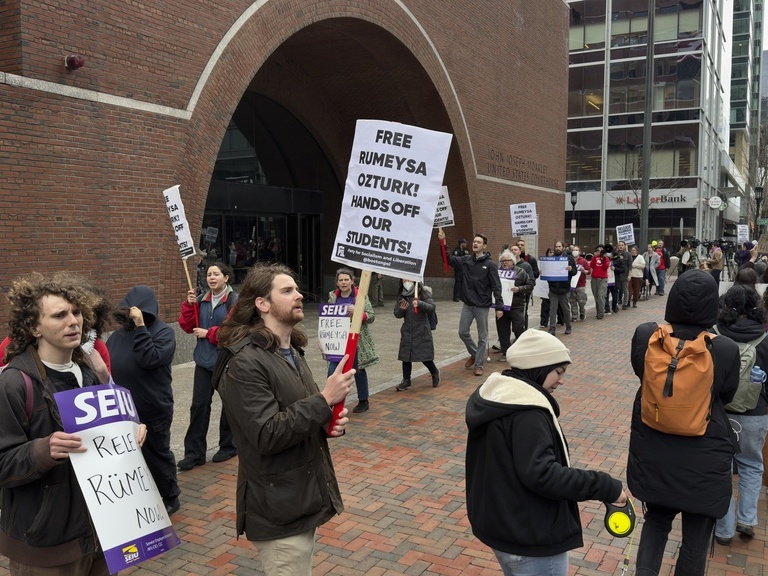 caption: Protesters gather outside federal court during a hearing with lawyers for Rumeysa Ozturk, a Tufts University doctoral student from Turkey who was detained by immigration authorities, in Boston.