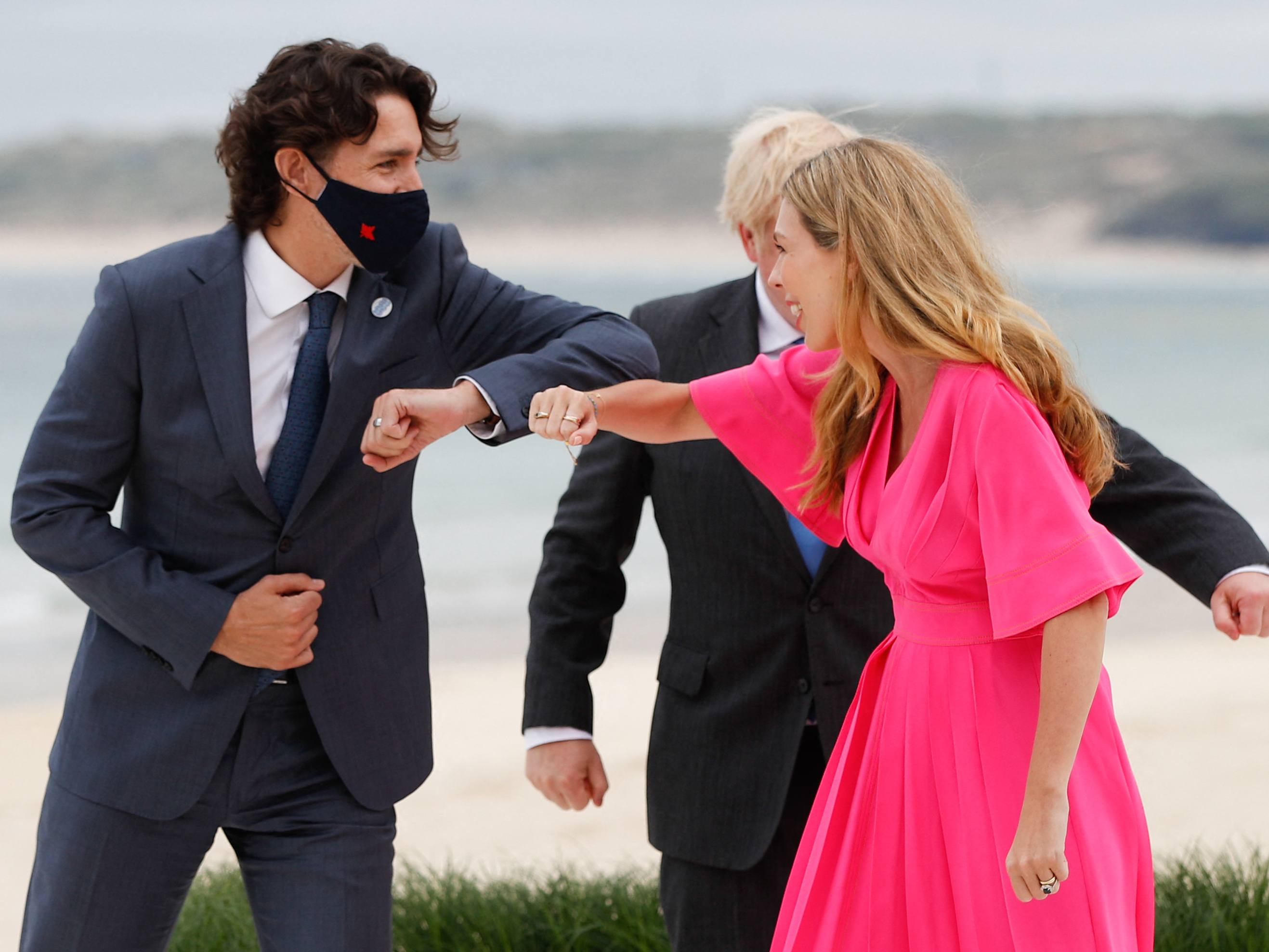 caption: Canadian Prime Minister Justin Trudeau greets Johnson, the G-7 host, and his wife, Carrie, as he arrives for Friday's summit.