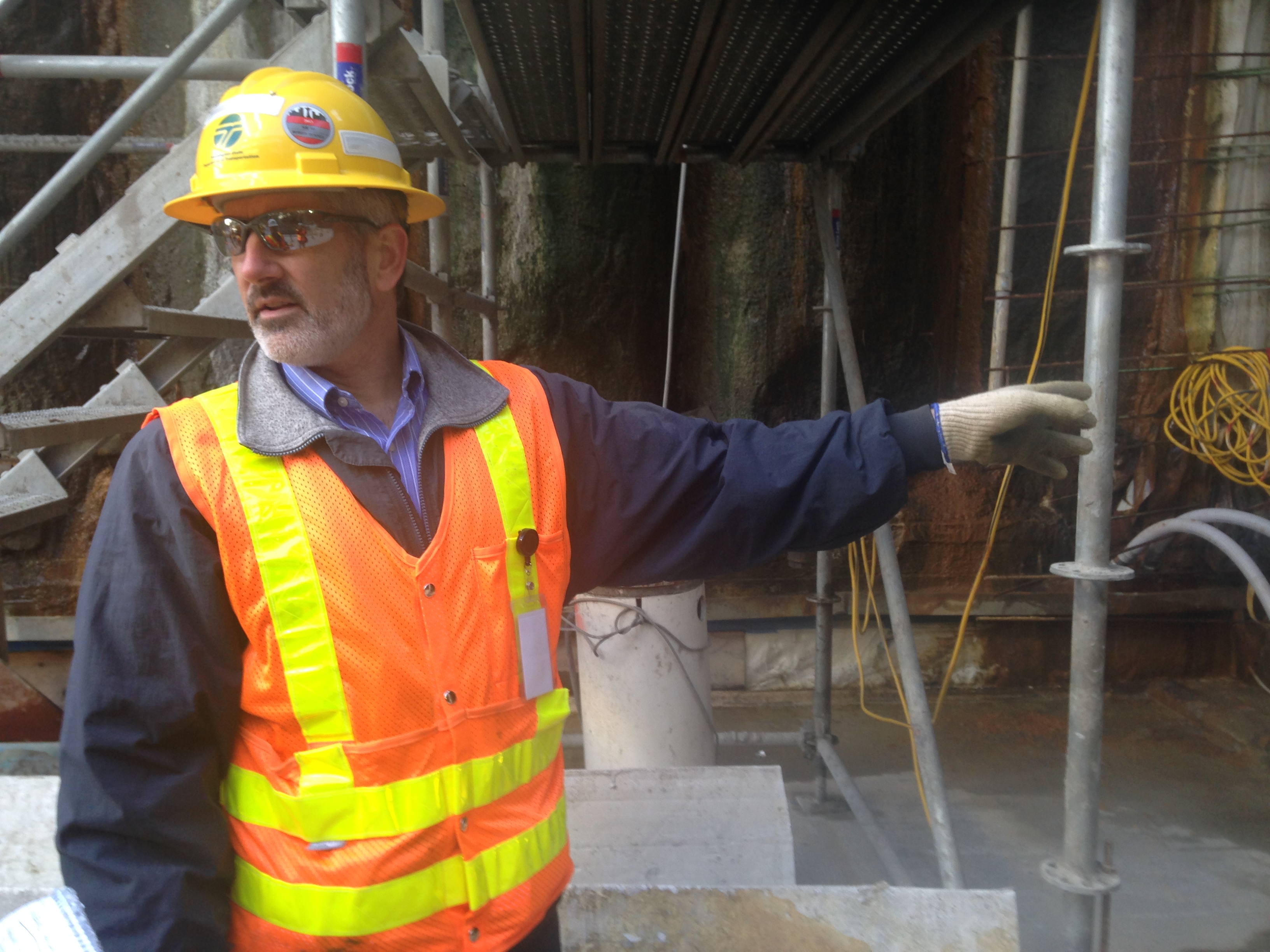 caption: Washington Department of Transportation's Matt Preedy points out the new roadway that will lead into the tunnel. 