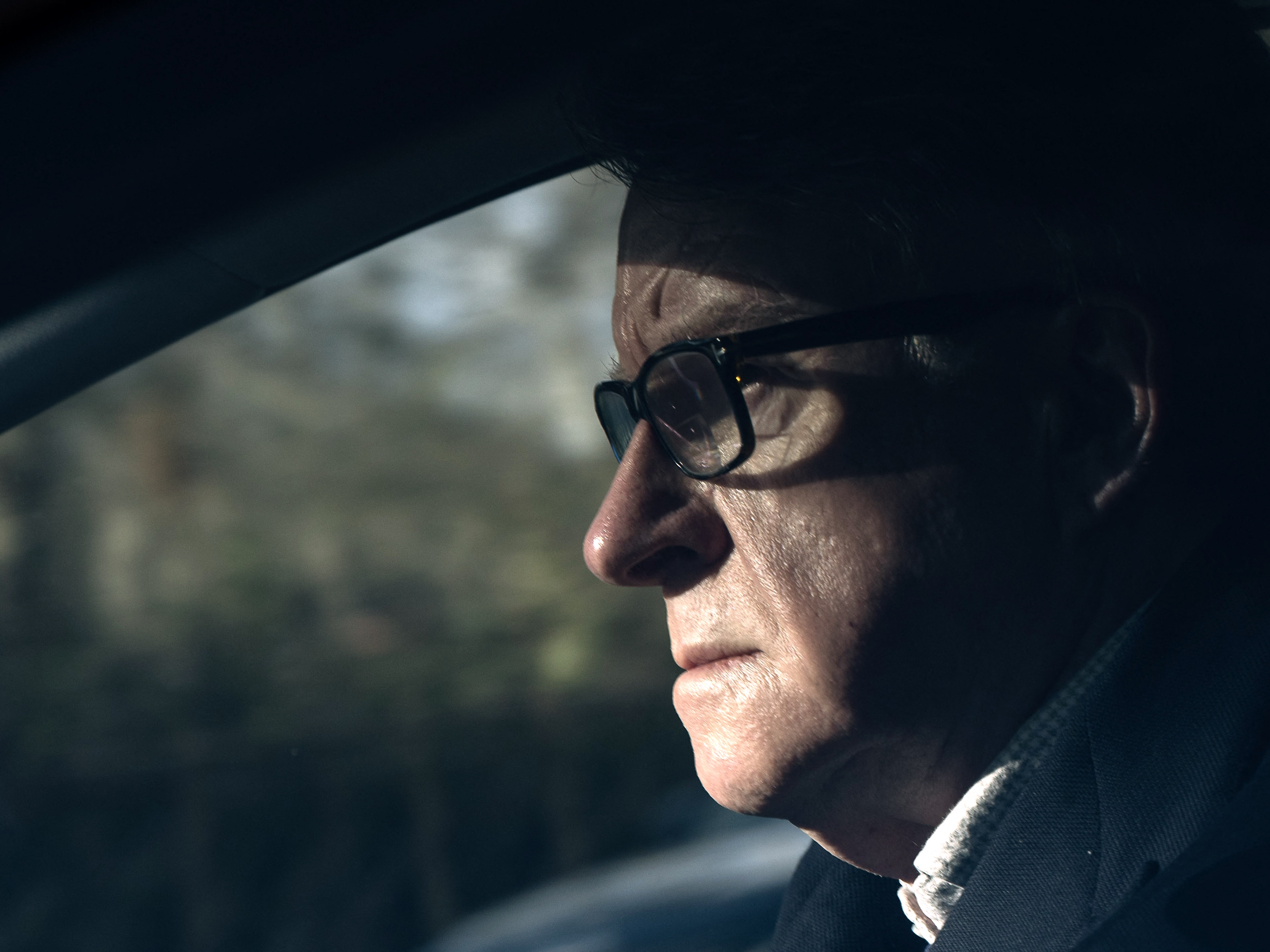caption: Former U.K. Ambassador to the United States Peter Mandelson drives away from his residence in central London on Feb. 14.