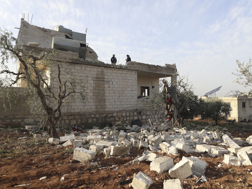 caption: People check a destroyed house after a U.S. military operation in the Syrian village of Atmeh, in Idlib province, on Thursday. U.S. special forces carried out what the Pentagon said was a successful, large-scale counterterrorism raid. Local residents and activists said civilians were also among the dead.