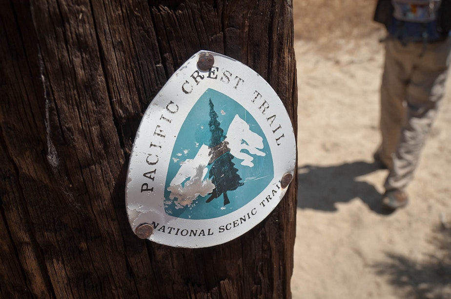 caption: A trail marker designating the Pacific Crest Trail.