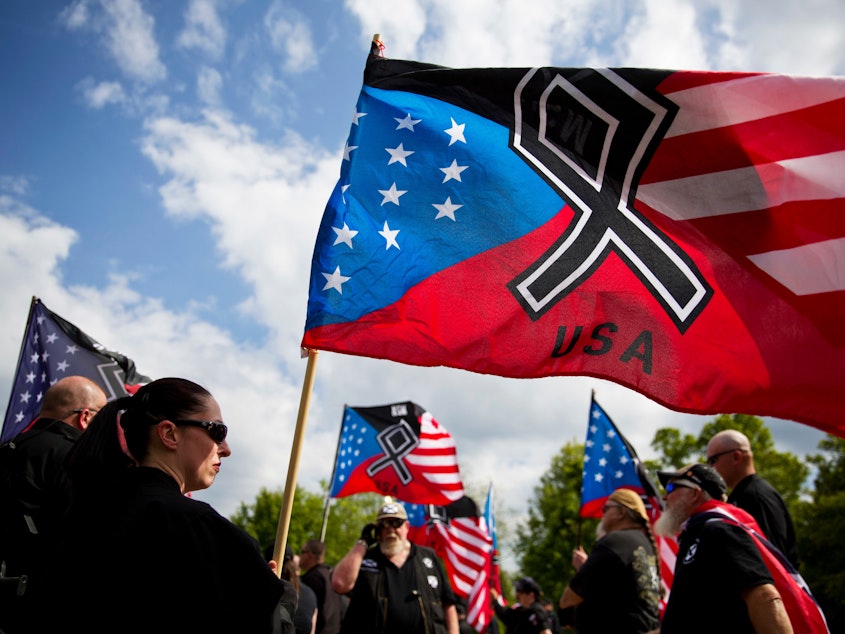 caption: The National Socialist Movement, a neo-Nazi group that has been designated a hate group by the Southern Poverty Law Center, held a rally in Newnan, Ga., in April 2018.