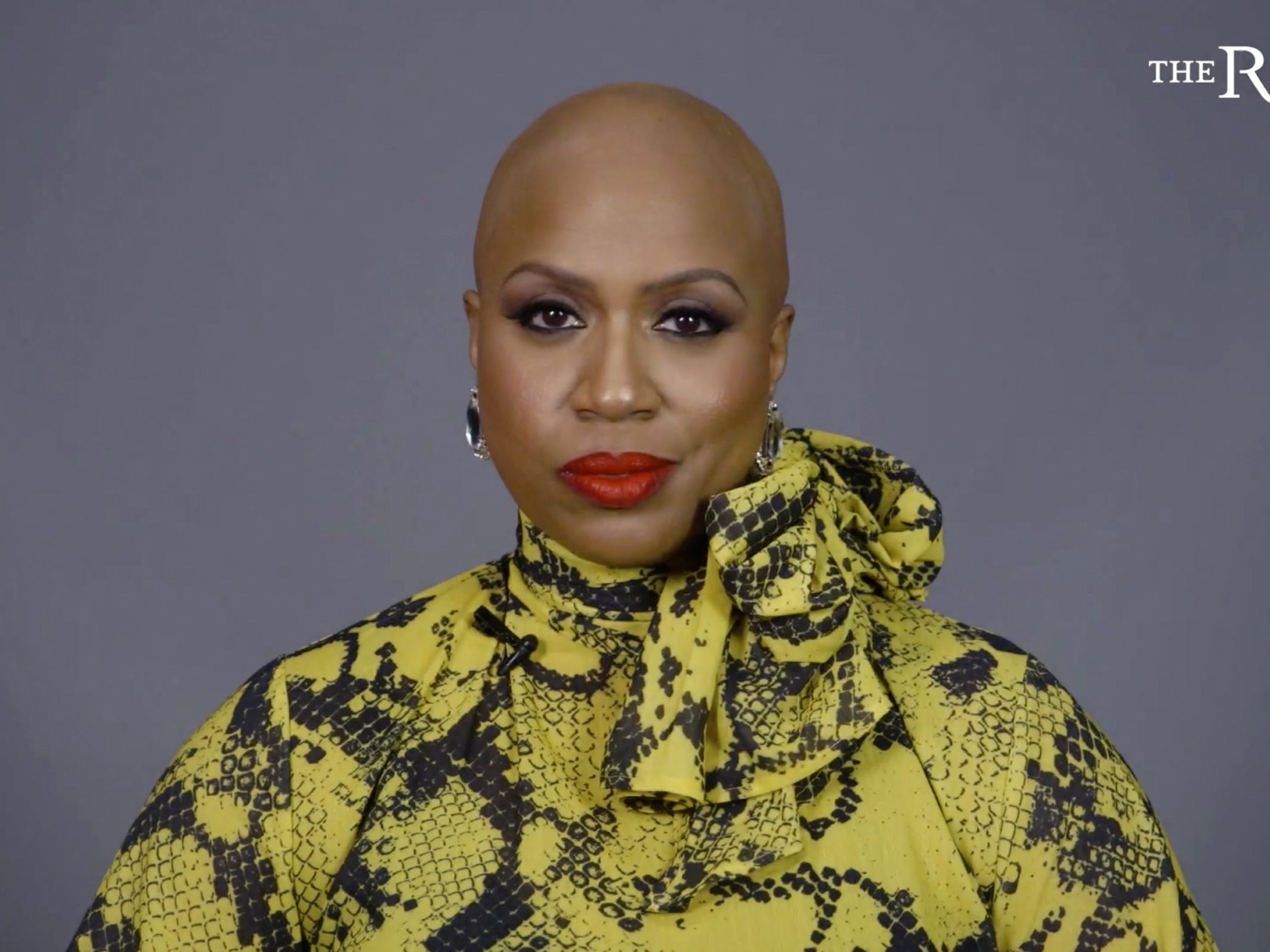 caption: Rep. Ayanna Pressley appears in a video for The Root, the African American-focused online magazine, in which she reveals her bald head and talks about living with alopecia.