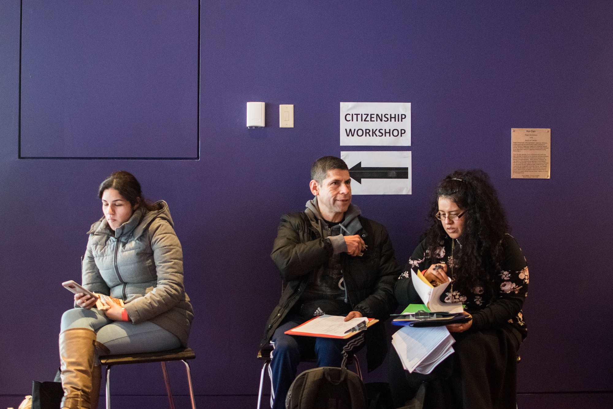 caption: People wait to attend a citizenship workshop in Seattle.