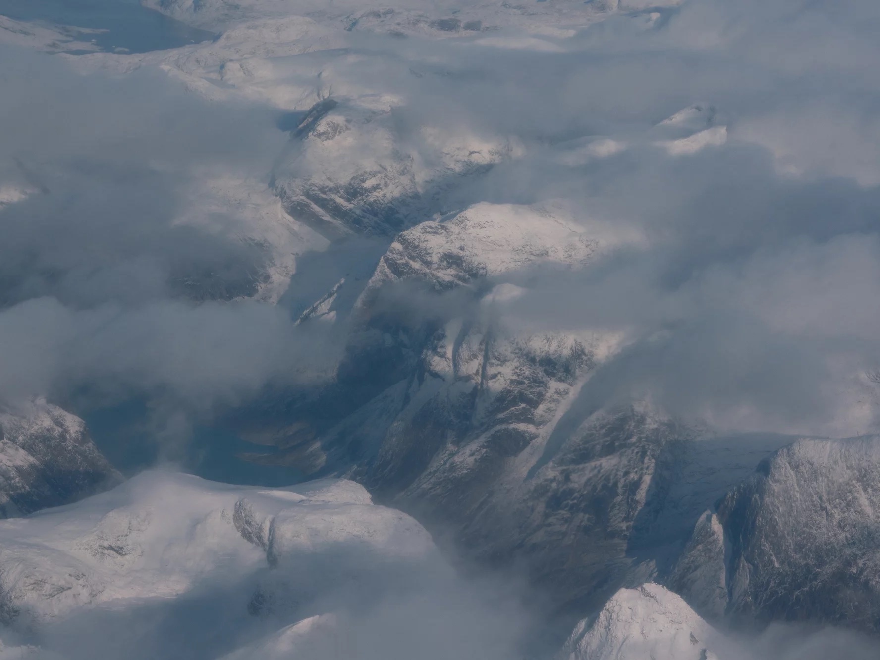 caption: An aerial view of mountains just north of Nuuk. Greenland is bigger than Mexico with a sparse population of just 56,000 people.