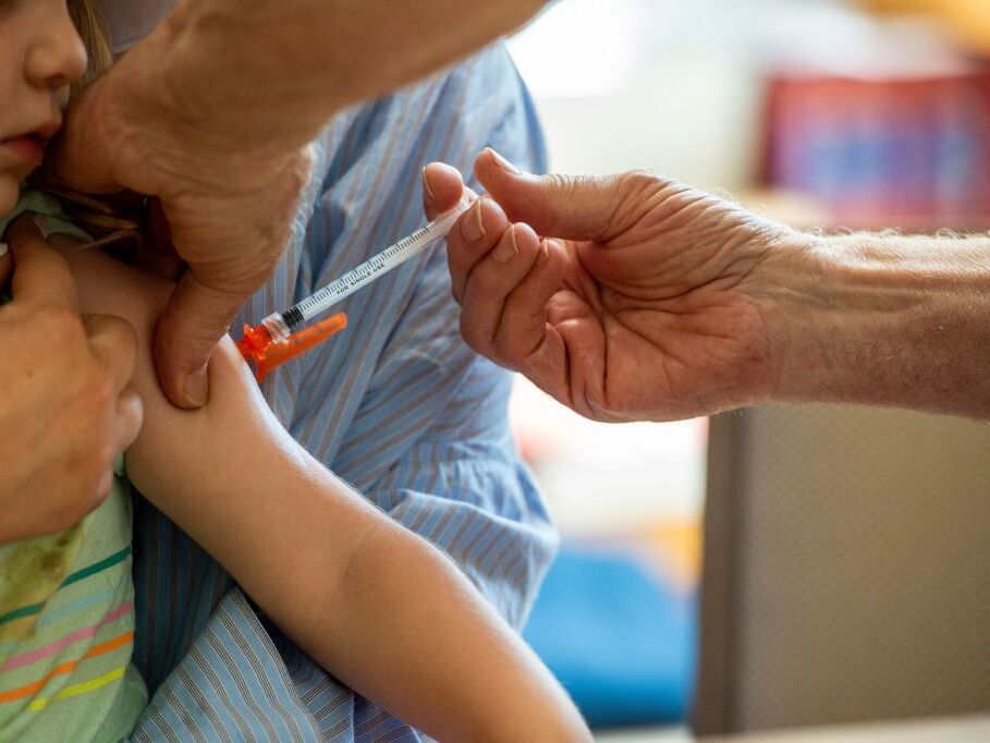 caption: It's been hard for parents to get their kids COVID shots recently, as well as for many healthy adults, since the CDC hasn't weighed in with official guidelines for administering them.