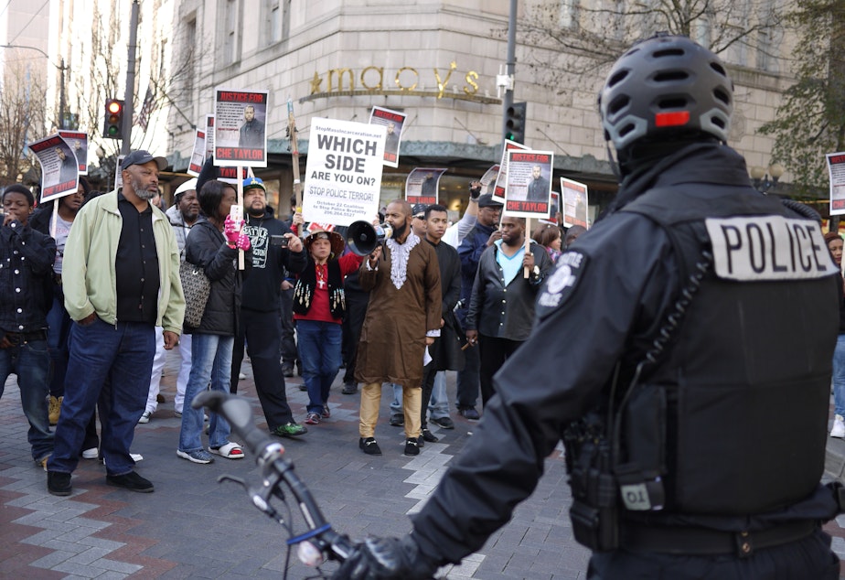caption: A march protesting the Seattle police shooting of Che Taylor on Feb. 21 moves through downtown Seattle on Feb. 25.