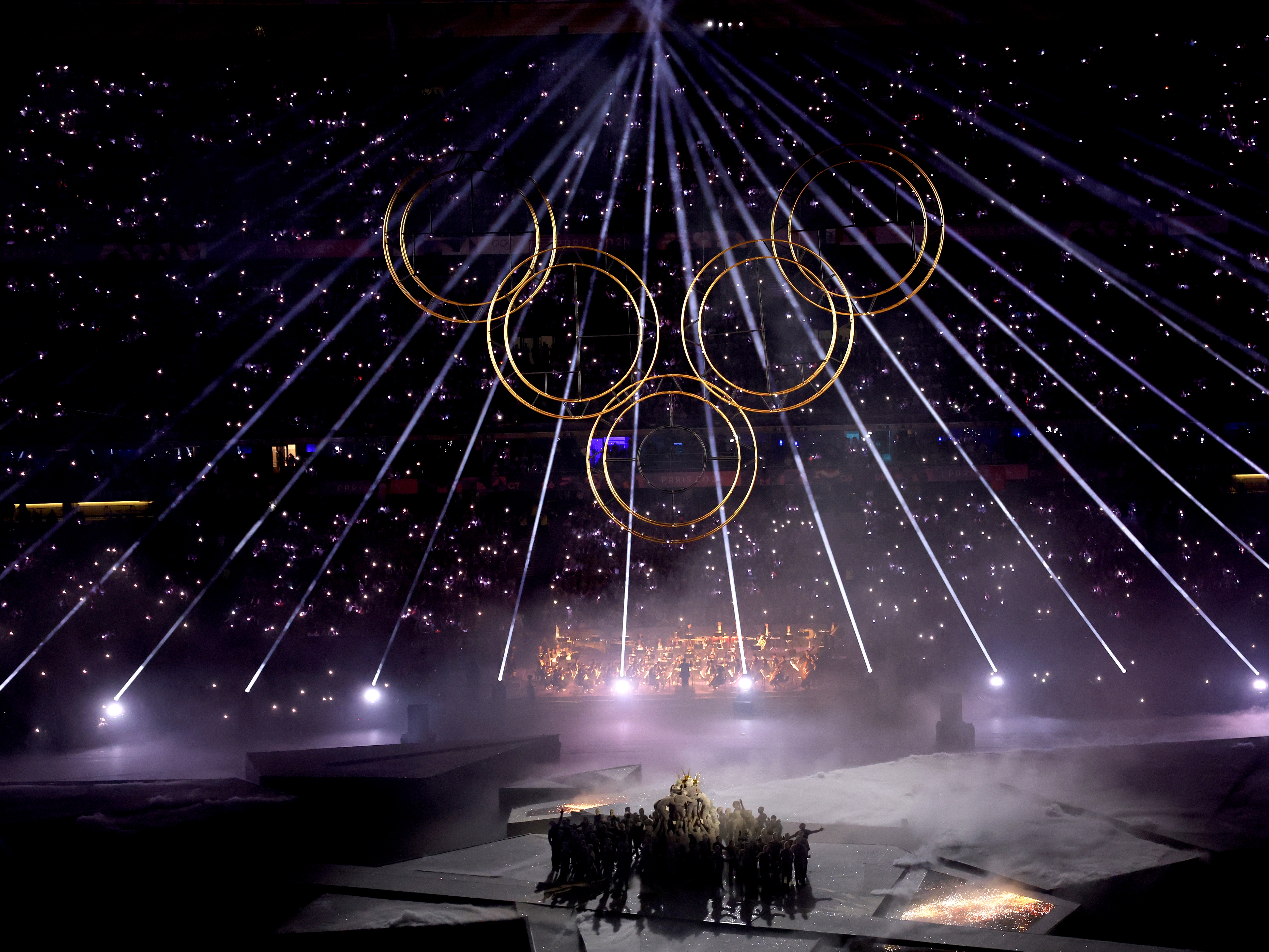 caption: A general view as the final Olympic Ring is lifted into place to assemble the Olympic Rings during the Closing Ceremony on Sunday.