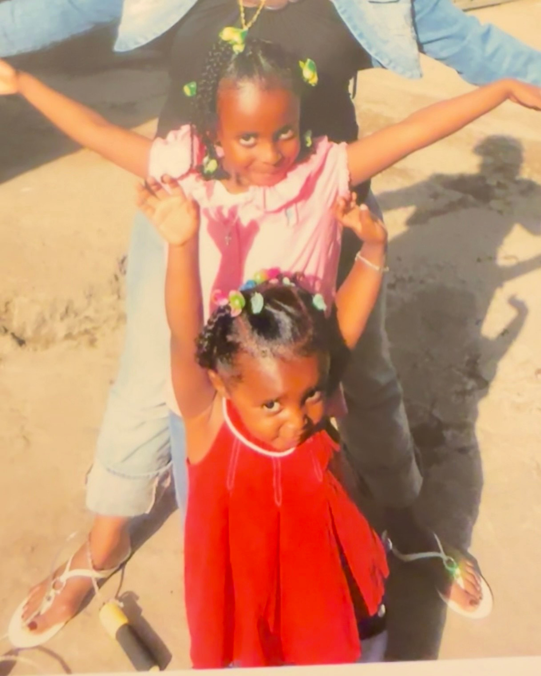 caption: Rediet Giday (bottom) and her sister, Bitaniya Giday, as children.
