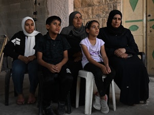 caption: The family of Bilal Muhammed Saleh outside their home in  As-Sawiya, occupied West Bank on Oct. 31, 2023.