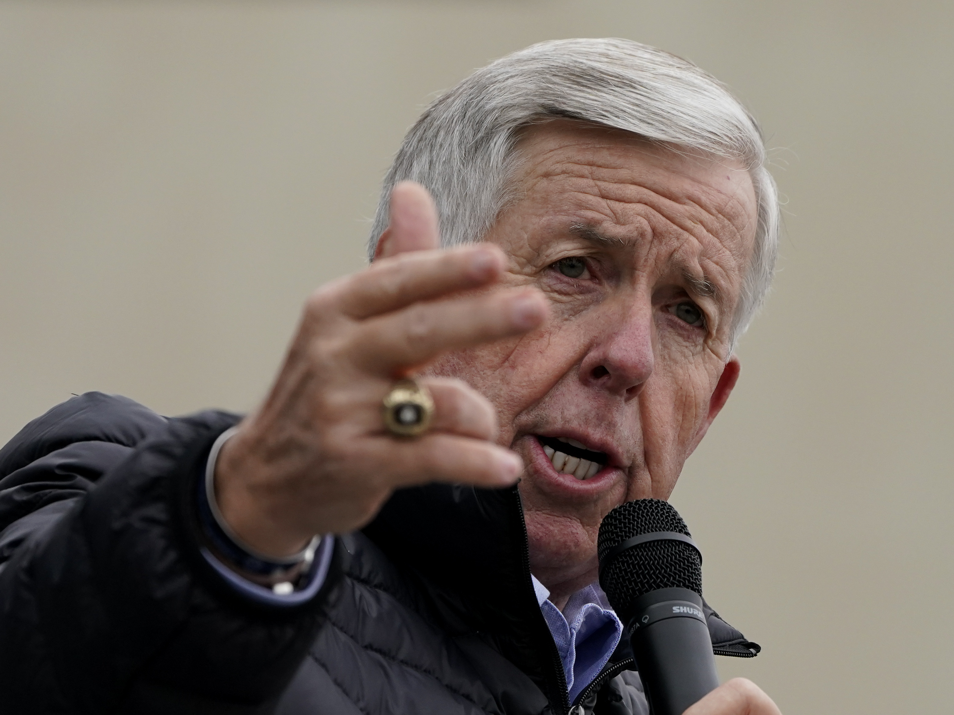caption: Missouri Gov. Mike Parson speaks during a campaign rally at a gun store in Lee's Summit, Mo., last October. Parson has signed into law a measure that could fine state and local law enforcement officers $50,000 for helping to enforce federal gun laws.