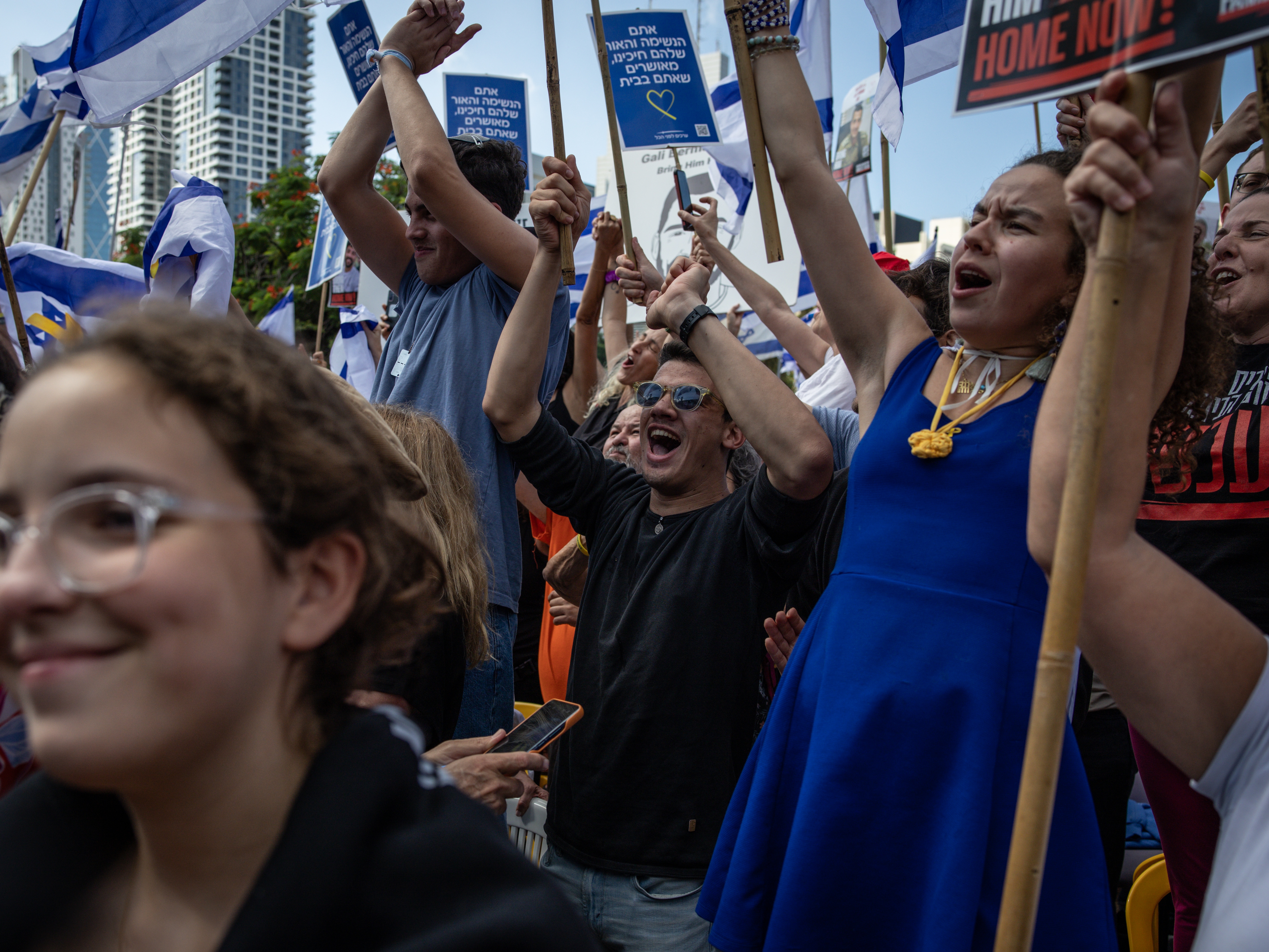 caption: Israelis react as they wait for the release of Israelis still held in Gaza at Hostages Square in Tel Aviv early on Oct. 13, 2025.