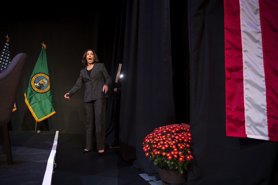 caption: Senator and democratic presidential candidate Kamala Harris reacts to the crowd as she walks onto the stage before the start of a gun safety roundtable on Friday, September 27, 2019, at Langston Hughes Performing Arts Institute in Seattle.