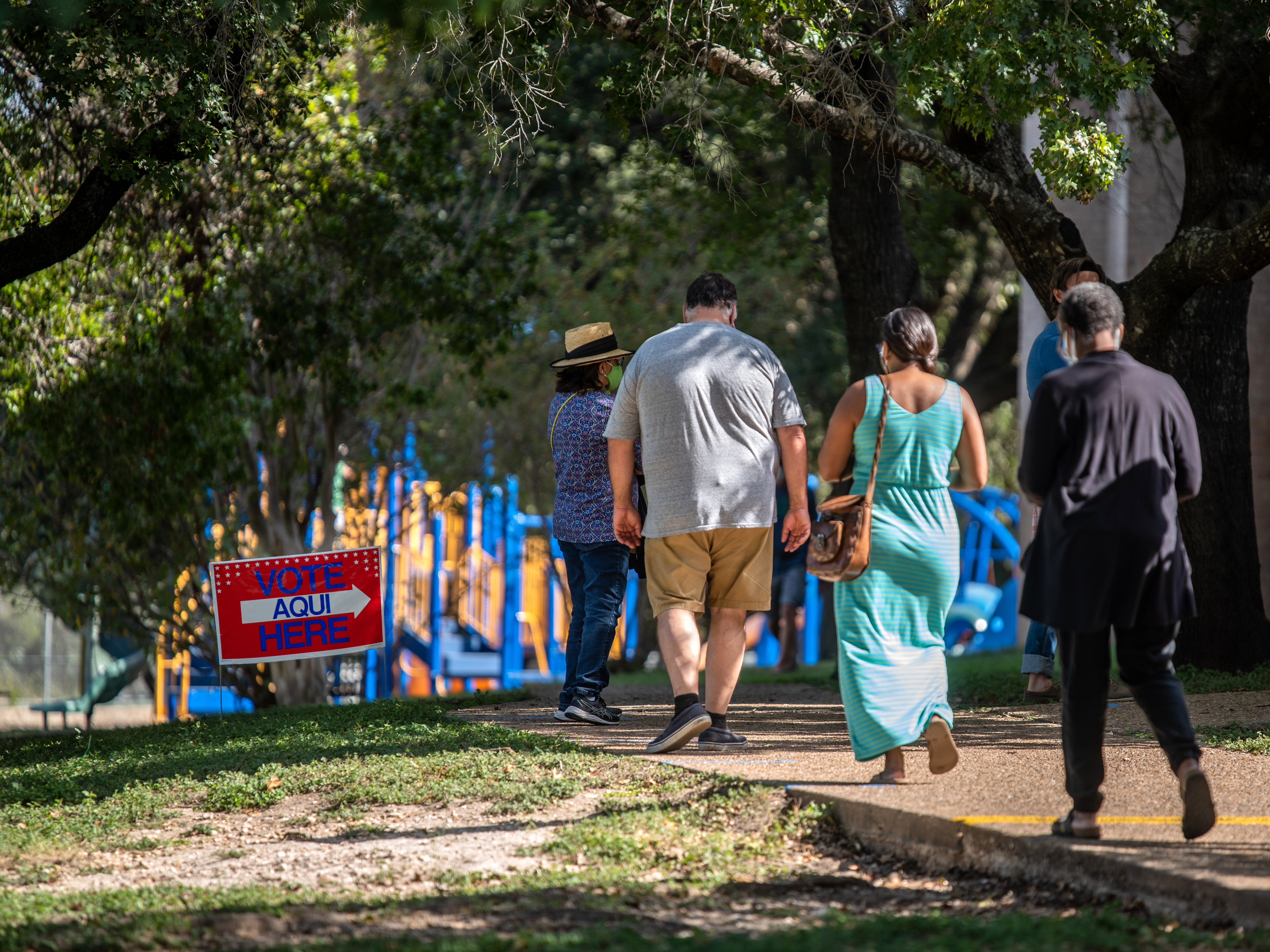 caption: Voters approach a polling location in Austin, Texas, on Oct. 13 — the first day of voting in the state. More than 7 million votes have been cast in Texas already.