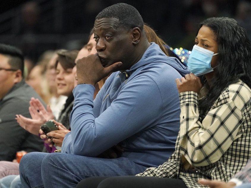 caption: Former Seattle SuperSonics forward Shawn Kemp (center) was booked into jail Wednesday, on a felony charge stemming from a shooting. He's seen here last year, at a WNBA game between the Seattle Storm and the Chicago Sky.
