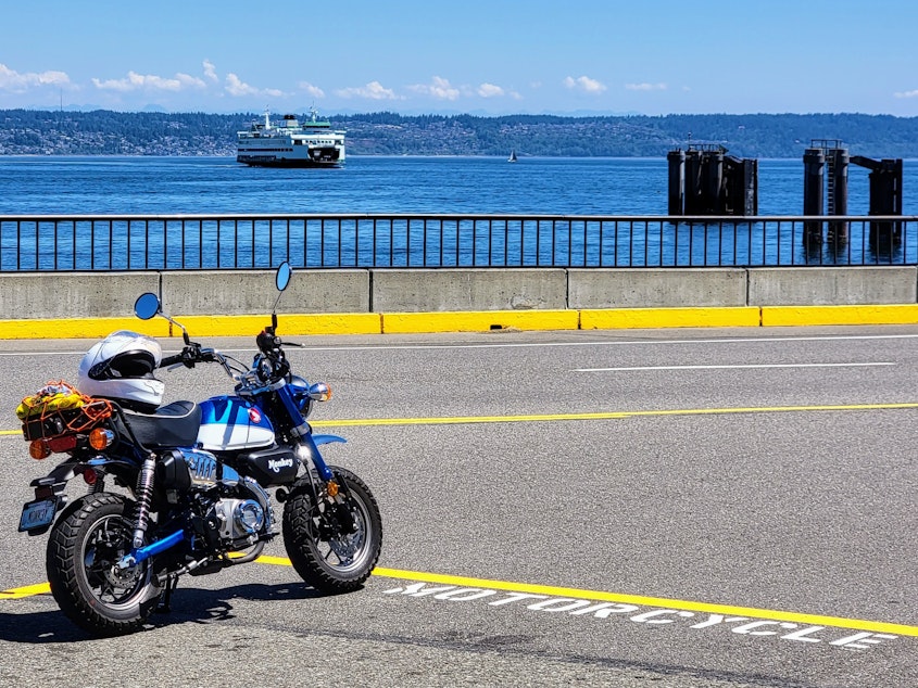 caption: A motorcycle parked in the motorcycle staging area at the Kingston ferry dock.