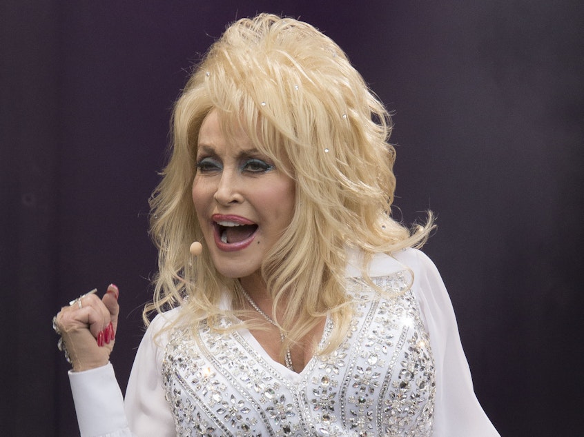 caption: Dolly Parton performs on the main Pyramid stage at Glastonbury music festival, England on June 29, 2014.