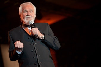 caption: Kenny Rogers performs during Muhammad Ali's Celebrity Fight Night XX in Phoenix, Ariz., in 2014.