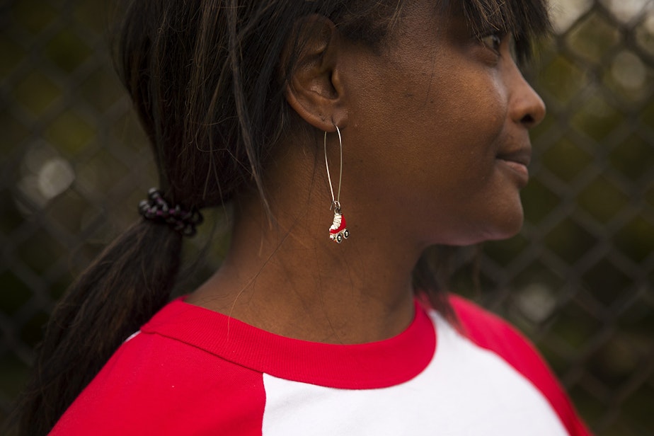 caption: Tiffany Mason, founder of Roll Around Seatown, stands for a portrait wearing roller-skate earrings on Tuesday, September 22, 2020, at the Judkins Park sports court in Seattle.