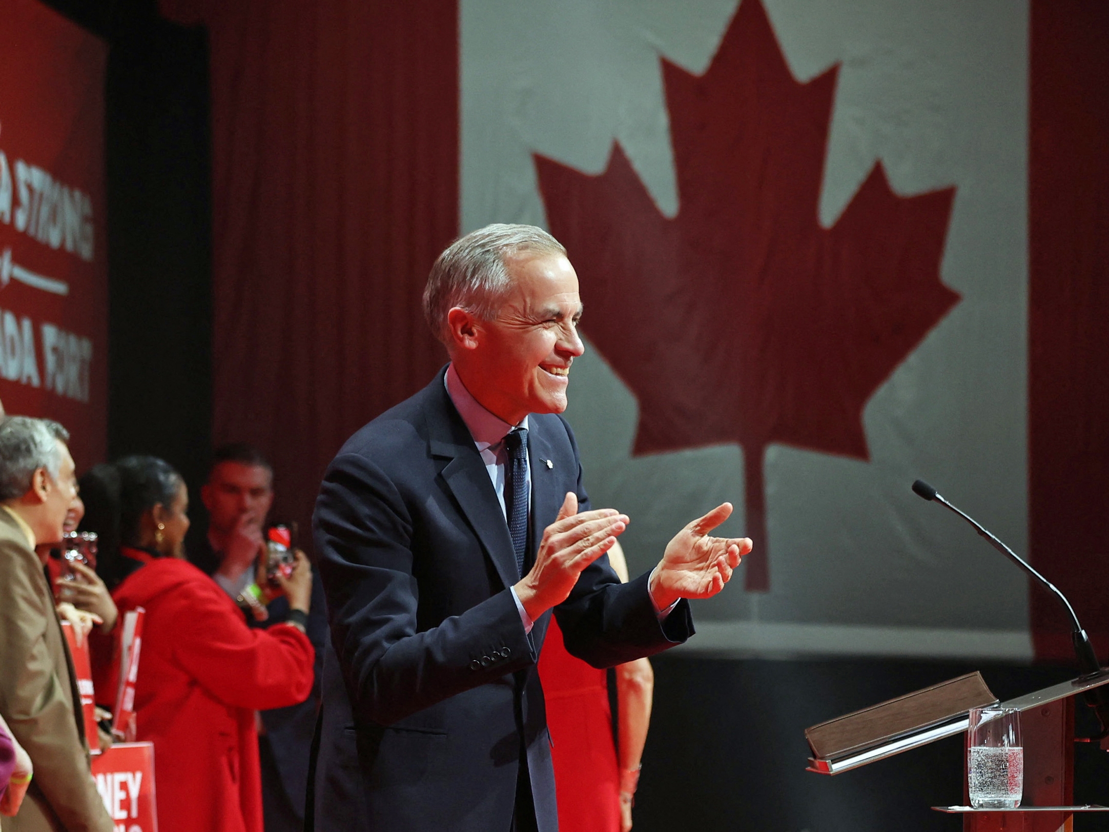 caption: Mark Carney addresses supporters after winning the Liberal Party election on Sunday. He is due to be sworn in on Friday.