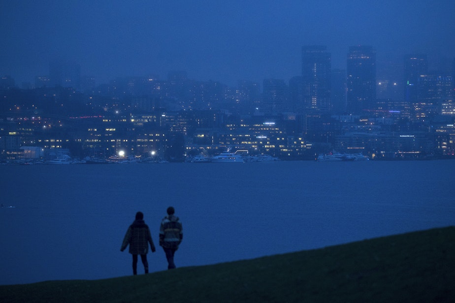 caption: People watch the sun set over downtown from Gas Works Park on Wednesday, December 4, 2019, in Seattle.