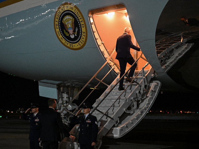 caption: President Biden boards Air Force One on Feb. 26 after a quick trip to New York for a campaign event.