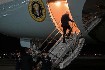 caption: President Biden boards Air Force One on Feb. 26 after a quick trip to New York for a campaign event.